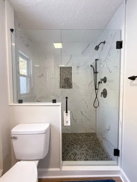 Compact shower enclosure with black fixtures
