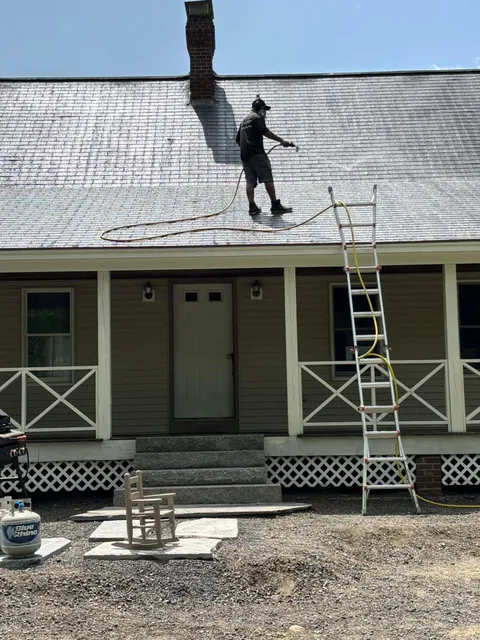 ACE Soft Wash owner cleaning a roof