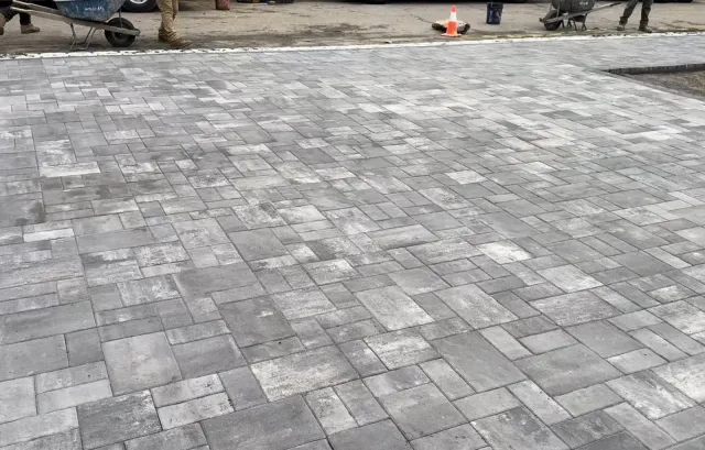 Completed gray paver patio with a precise running pattern
