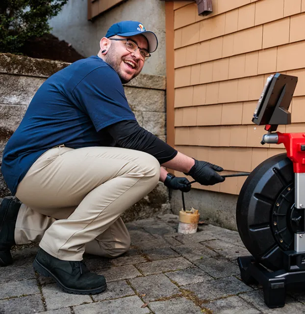 GEM technician inspecting outdoor HVAC unit at residential home