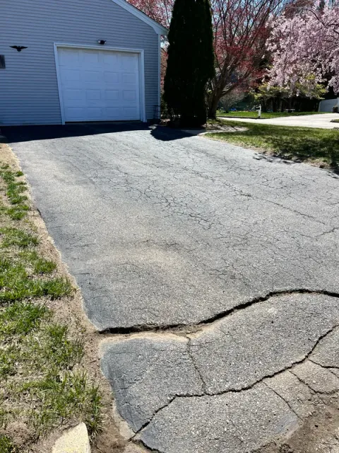 Asphalt surface showing cracks requiring inspection and cleaning before treatment