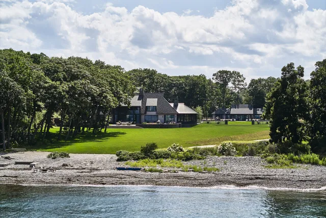 Luxurious waterfront home surrounded by lush greenery in Maine.