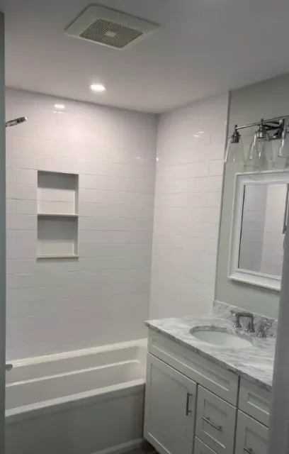 Tub and shower surround finished with white subway tile