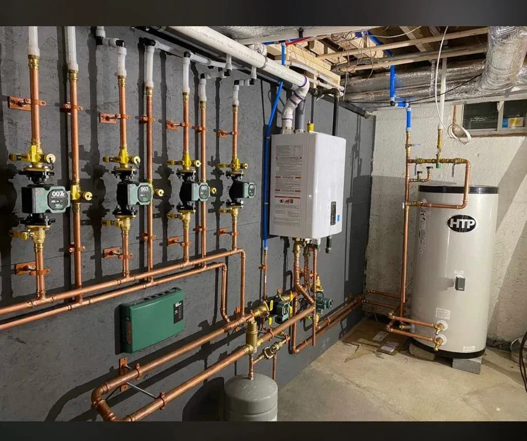 RW Plumbing team installing high-performance boiler system