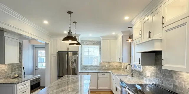 Modern kitchen with recessed, under cabinet and hanging lights