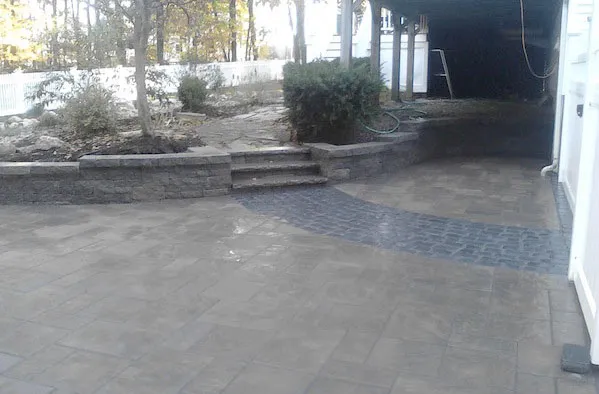 photo of a paver driveway and retaining wall built by Ideal Landscape of Holden MA