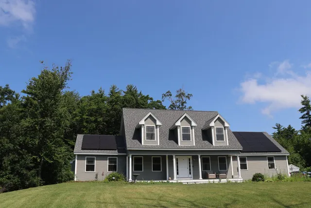 Completed WattsUp solar installation on a gray cape-style home