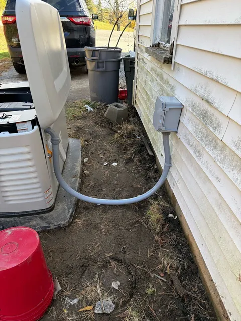 Standby generator on its pad with the conduit run from the unit to the house