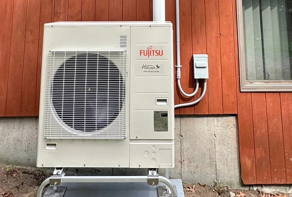 Heat pump installed outside a residential home for efficient heating and cooling, provided by Family Heating and Cooling in New Bedford, Fall River, Taunton, and surrounding areas. Call us now for help with heat pump installation, heat pump repair, heat pump maintenance, heat pump system, energy-efficient heat pumps, heating and cooling system, residential heat pump services, heat pump vs furnace, ductless heat pump, heat pump heating, heat pump for cooling, heat pump HVAC, heat pump system repair, best heat pump for home, affordable heat pumps, heating and cooling near me, heat pump services near me, heat pump installation in New Bedford, Taunton heat pump repair, Fall River HVAC services, heat pump maintenance in Somerset, Raynham heating solutions.