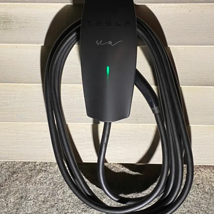 Tesla Wall Connector installed on exterior siding