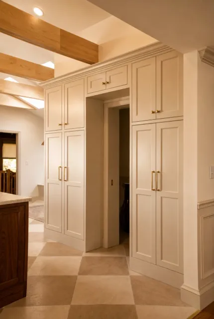 Floor-to-ceiling kitchen cabinetry with brass hardware