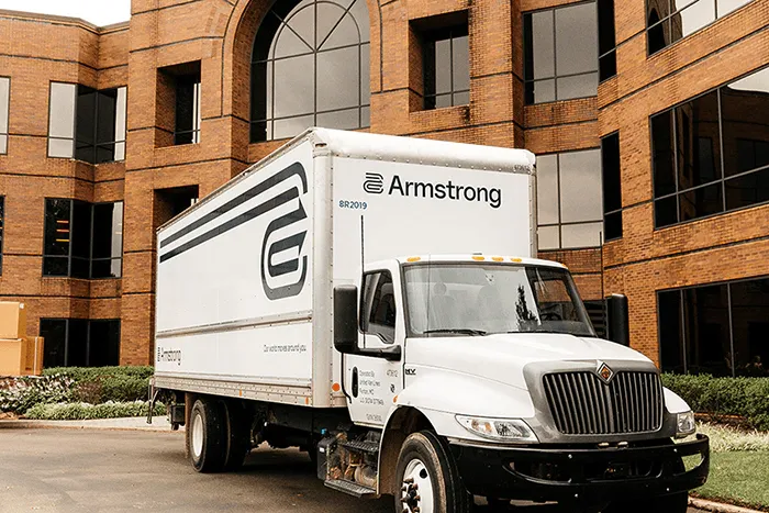 Armstrong’s moving truck in front of a building