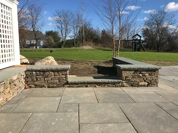 bluestone patio with stone sitting wall