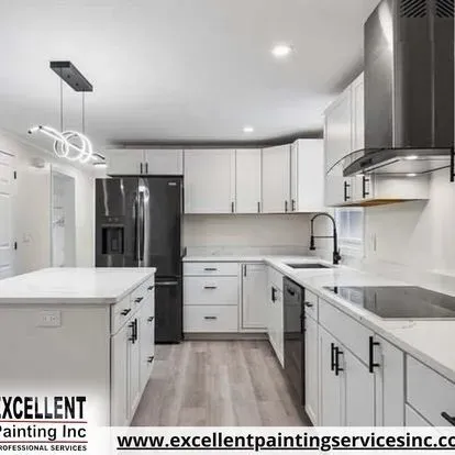 A kitchen with white cabinets and stainless steel appliances.