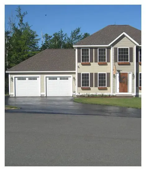 Image of a house that had driveway sealcoating in NH done to protect and seal their driveway.