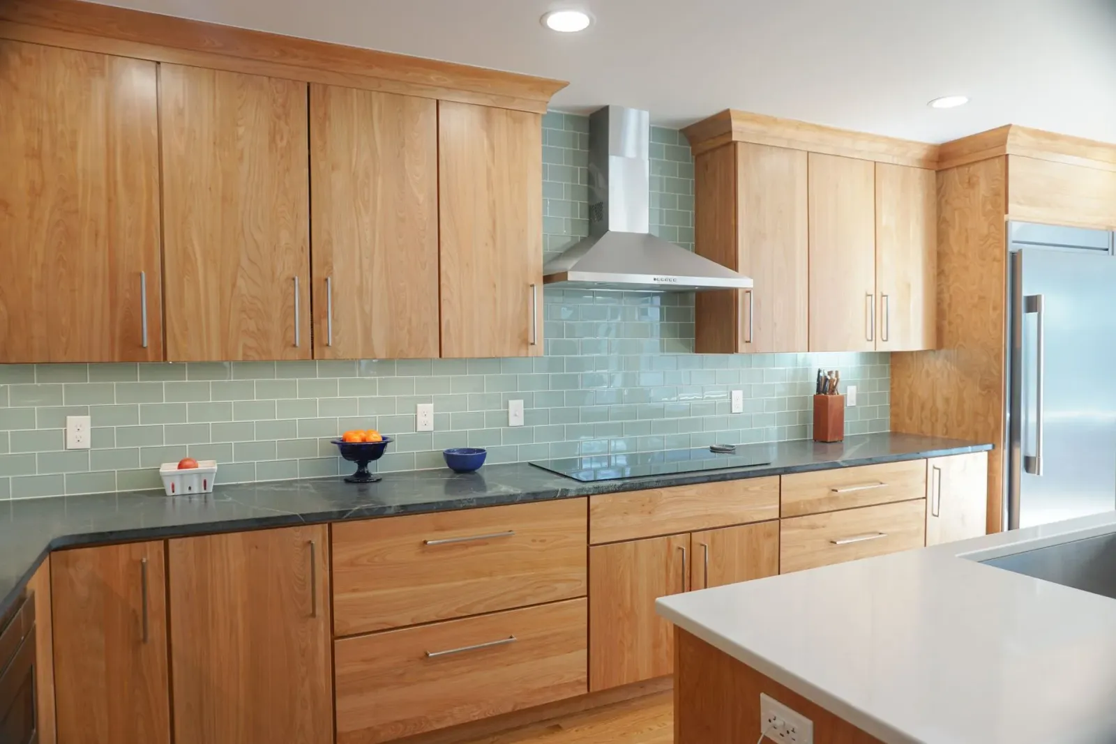 Modern kitchen with wooden cabinets, blue tile backsplash, kitchen by Chapdelaine Builders in East Longmeadow