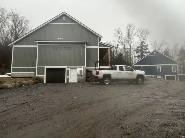 A truck is parked in front of a large building