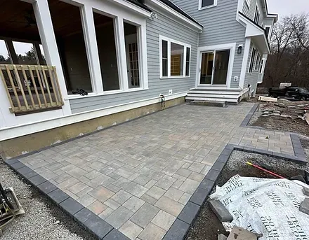 The installation of a new backyard paver patio in Acton, MA