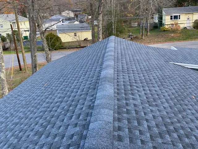 Gray asphalt shingle roof with a central ridge.