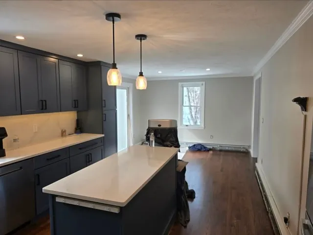 Kitchen with navy cabinetry and freshly painted walls and ceiling