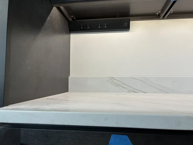 Hidden under-cabinet outlets and motion-sensor lighting
