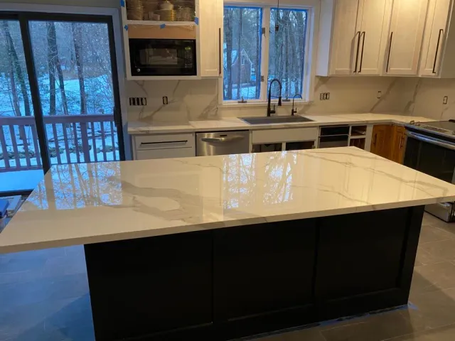 There is a large island in the middle of the kitchen.
