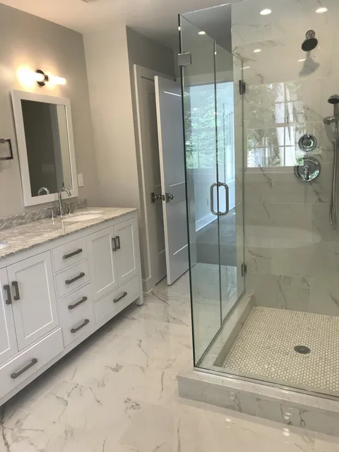 Marble bath with glass shower and custom vanity