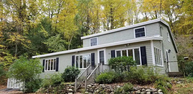 A home with forest behind it.