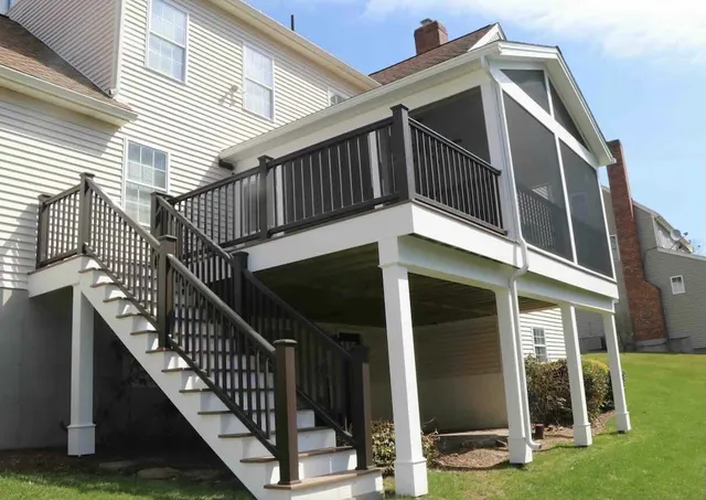 screened-in-porch-on-the-residential-under-deck-with-black-railing-in-worcester-ma.jpg