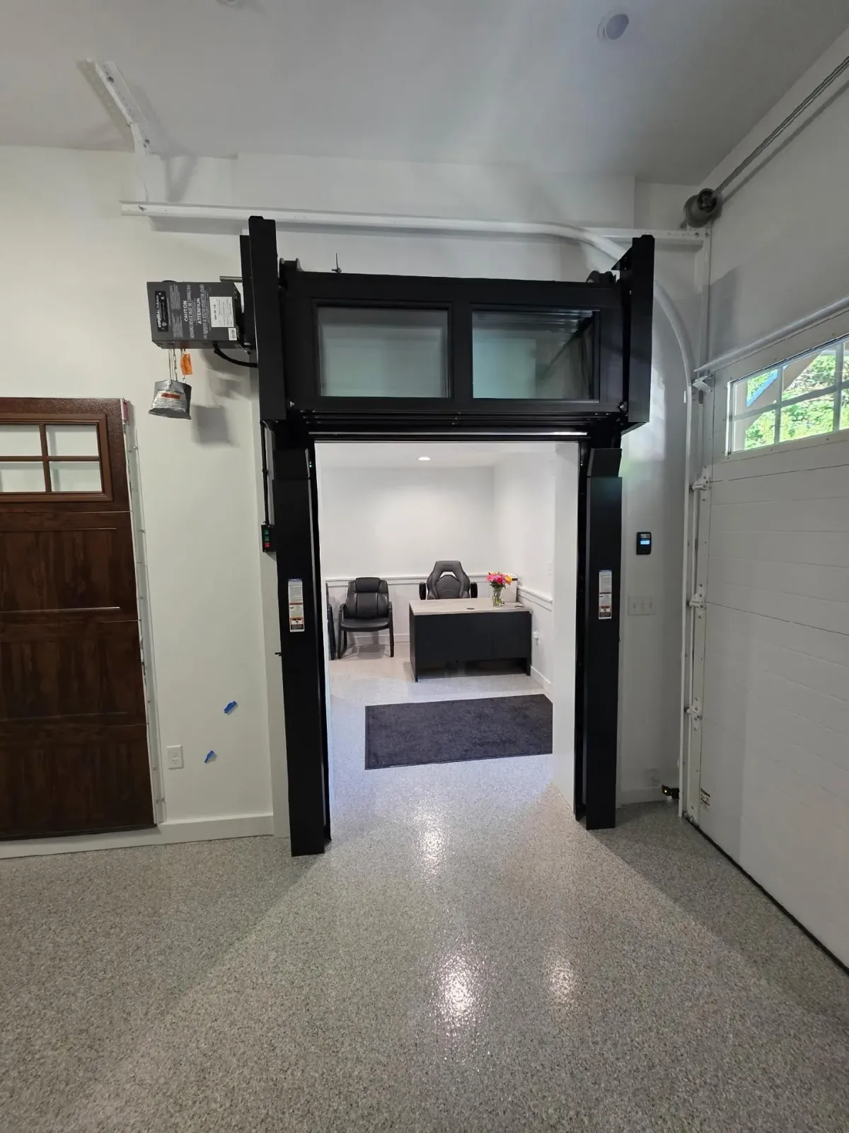Interior showroom with garage door styles on display.