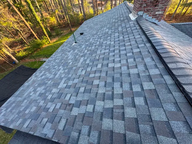 Roof replacement in progress with protected work area