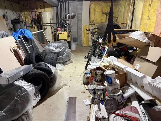 Same basement before, packed with tires, paint cans and building scrap