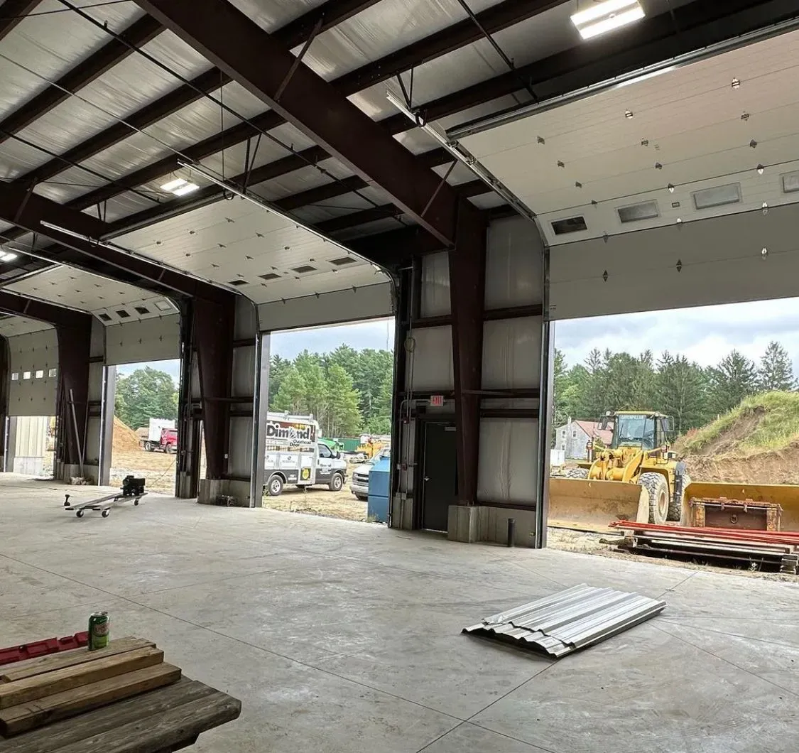 A large warehouse with a lot of doors open