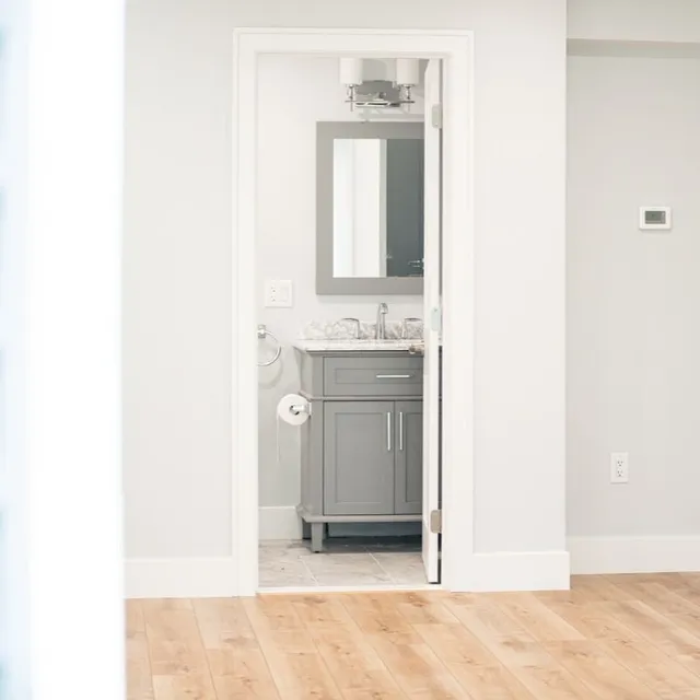 Finished powder room off a renovated hallway