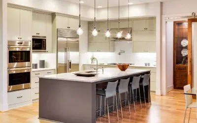 A kitchen with stainless steel appliances and a large island.