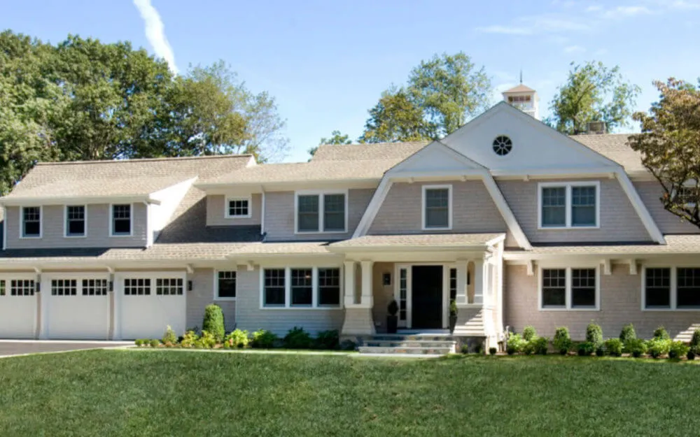Photo of two-story house with light siding and gables - Woodland Builders, South Shore MA.