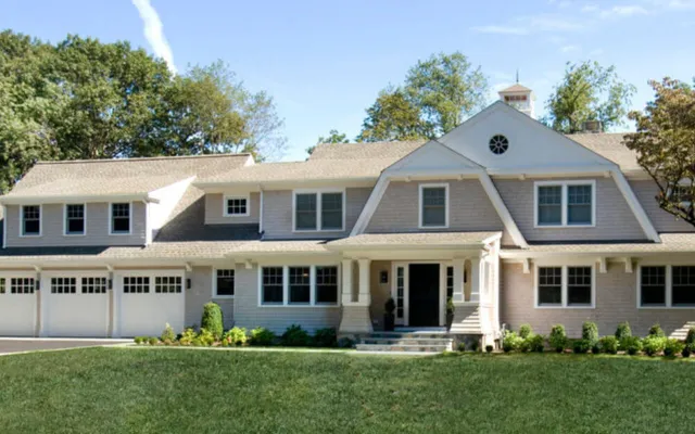 Photo of two-story house with light siding and gables - Woodland Builders, South Shore MA.