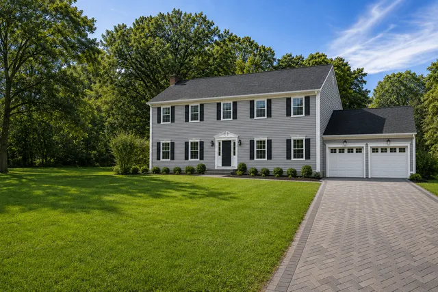 After: refreshed grey siding and rebuilt exterior on the same Connecticut colonial home completed by Stringa Construction