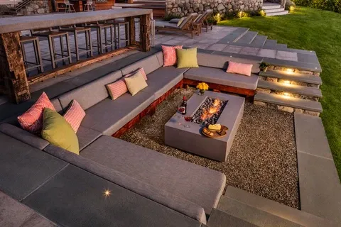 Outdoor gourmet area in Greenwich CT with custom seating and fire pit