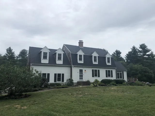 Colonial home exterior in Plympton, MA with a new shingle roof installed by Storm King Roofing
