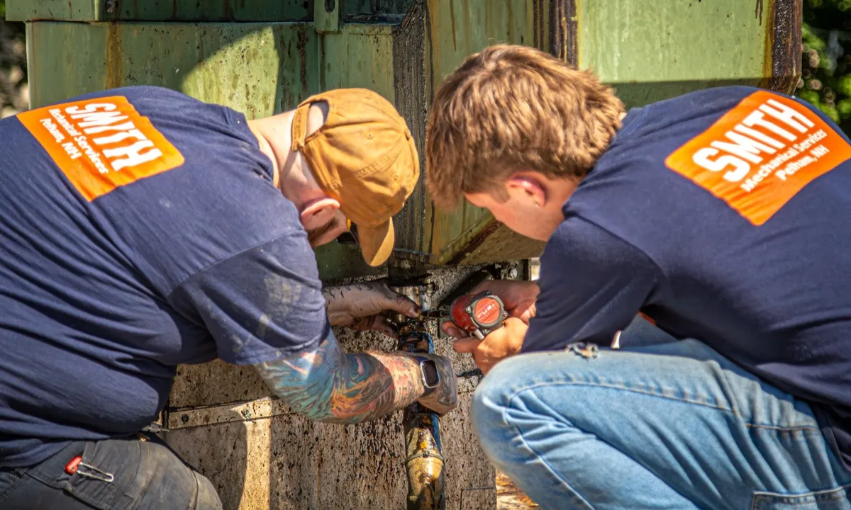 Technicians working on HVAC unit