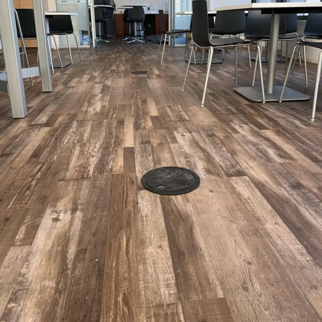 Rustic distressed wood-look vinyl plank flooring in cafe space by Link Services Pro in Shrewsbury, MA