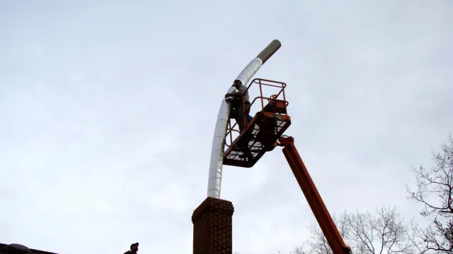 Installing chimney liner with crane
