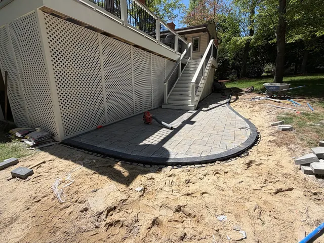 Three-piece paver field and curved coal border installation during Bellingham Massachusetts patio project