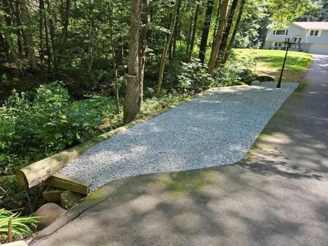 New crushed stone walkway laid through a shaded garden in Hudson, NH
