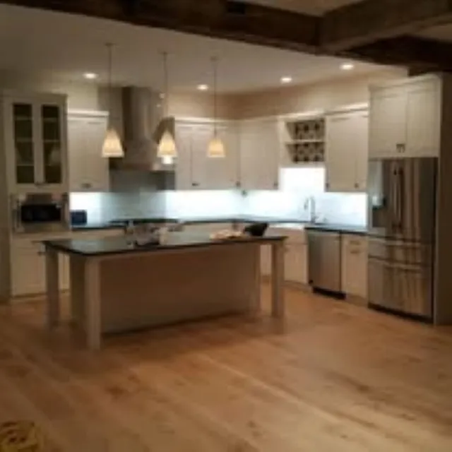 Modern kitchen with updated lighting and electrical renovations completed by Preferred Electrical Services, LLC