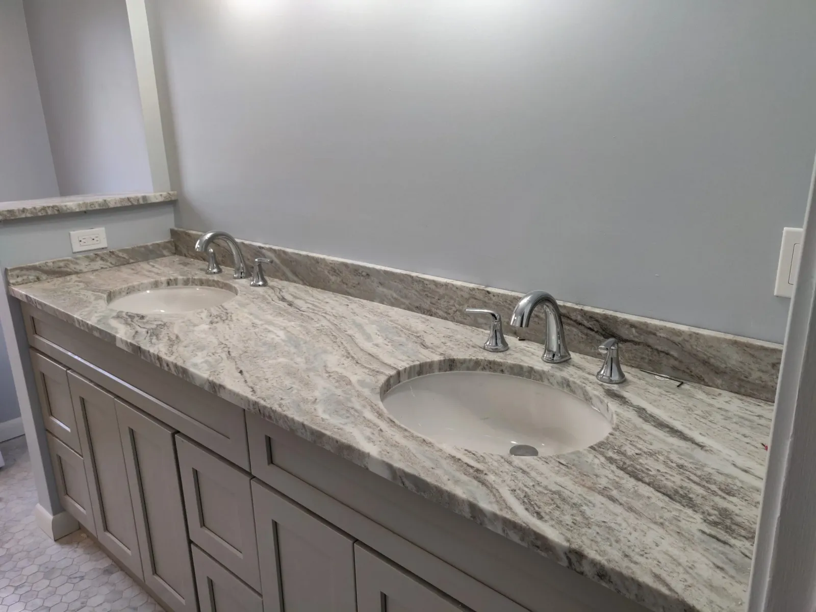 Bathroom vanity with granite countertop and two undermount sinks