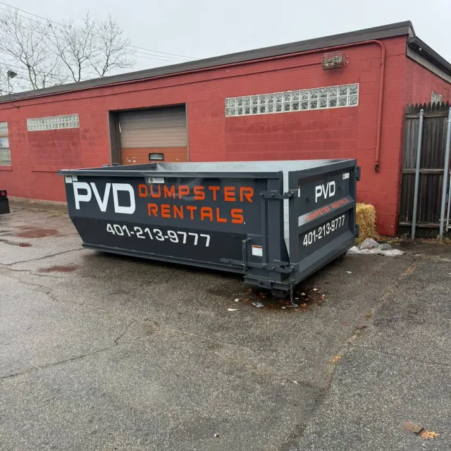 15 yard dumpster outside a warehouse on a commercial cleanout job in Rhode Island