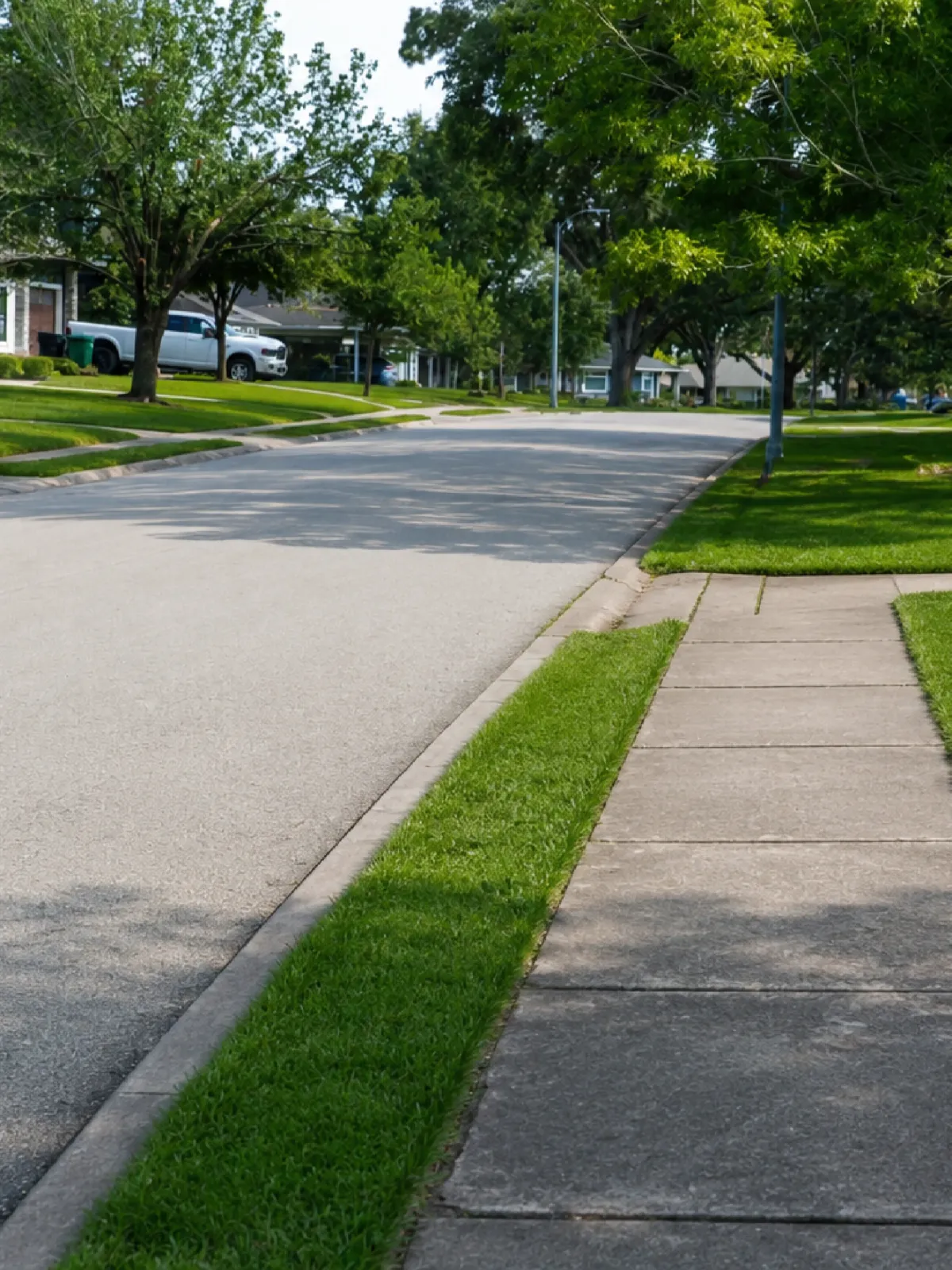 Empty sidewalk beside residential street