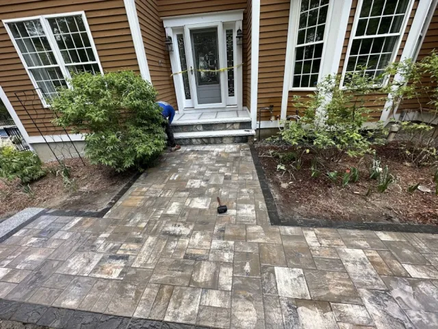 Grand entrance with pavers and granite steps